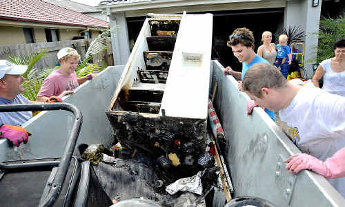 Brandon Fairless and Sam McArthur muck in yesterday to help Tamara Horn and her two-year-old son Lachlan clean up after a fire gutted their home on Saturday. Brandon Fairless and Sam McArthur muck in yesterday to help Tamara Horn and her two-year-old son Lachlan clean up after a fire gutted their home on Saturday.
